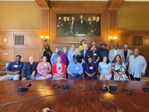 Collaborative members pose together and smile at the camera.