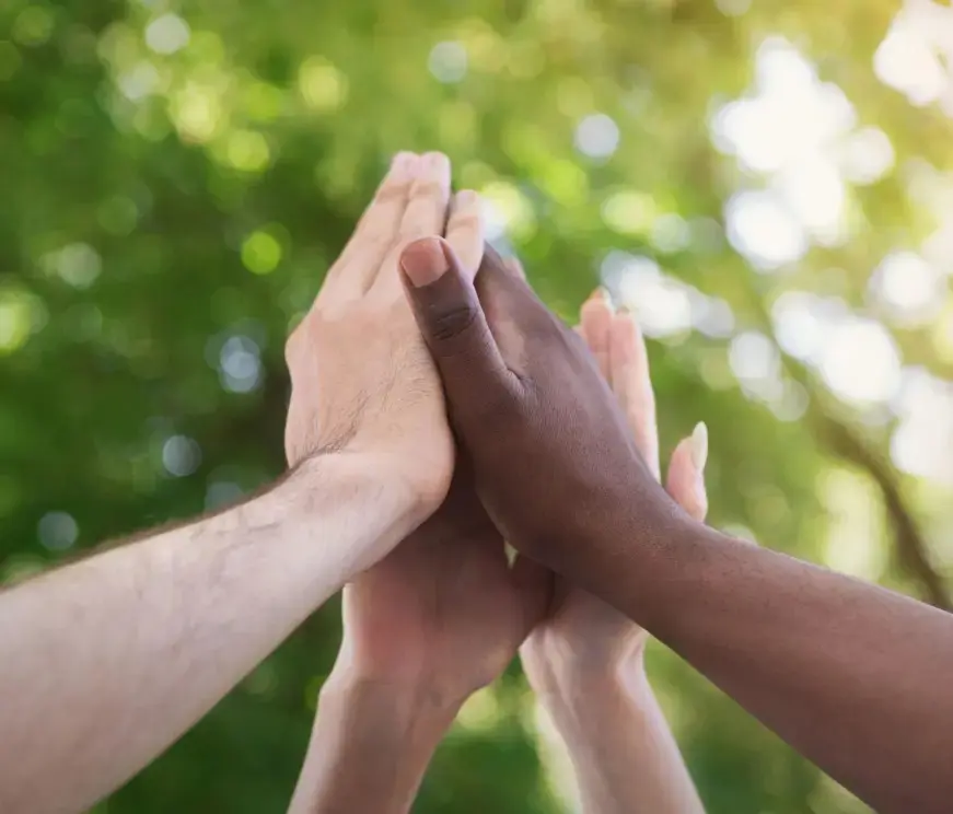 Hands high-fiving to show community partnership